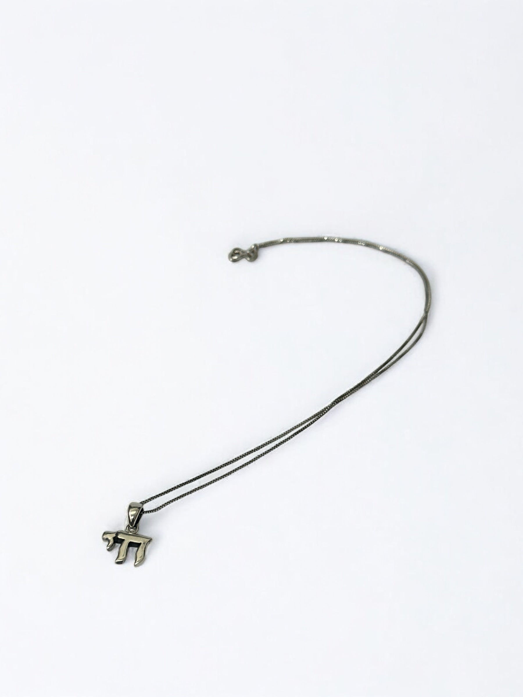 Close-up of Chai Hebrew letters on pendant