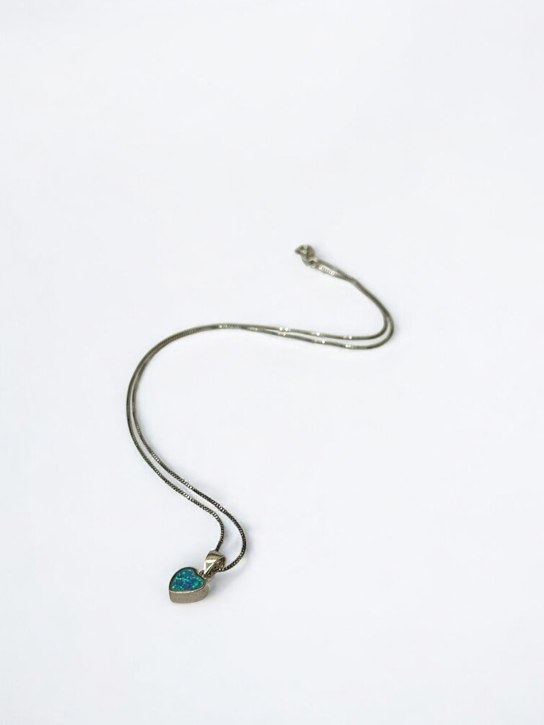 Close-up of opal stone in heart-shaped pendant