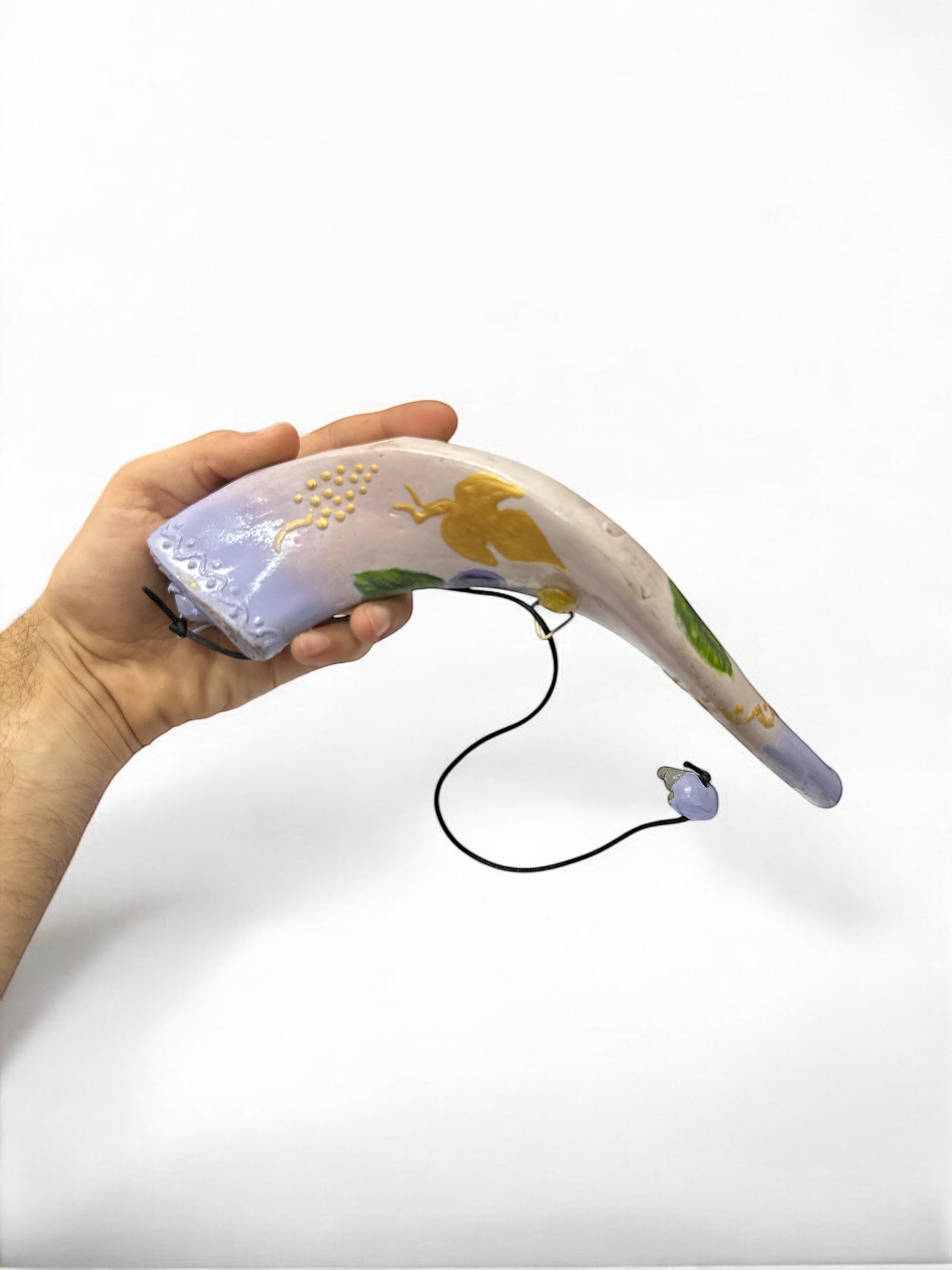 Side view of hand-painted shofar bottle showing scale